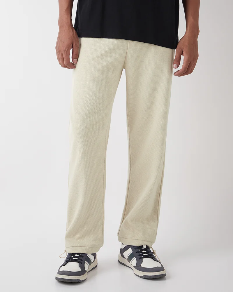 bewakoof Men's Beige Textured Oversized Parachute Pants